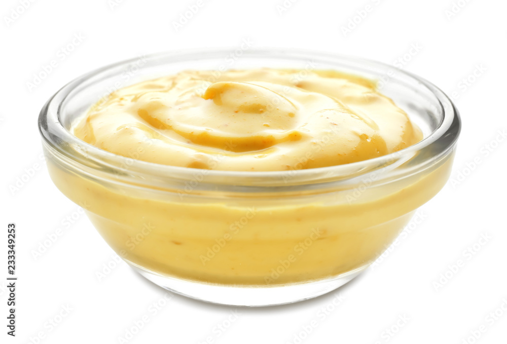 Tasty yellow sauce in bowl on white background Tasty yellow sauce in bowl on white background