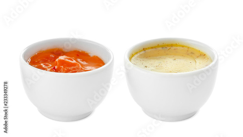 Tasty sauces in bowls on white background
