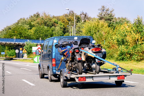 Mini van with motorcycles on trailer in Road Slovenia