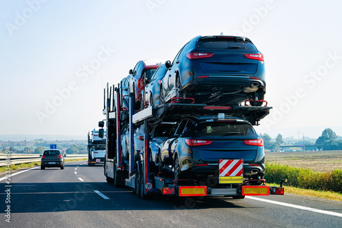 Cars carrier truck on asphalt road Poland