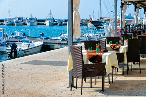 Sidewalk street cafe at Adriatic Sea and Marina in Izola