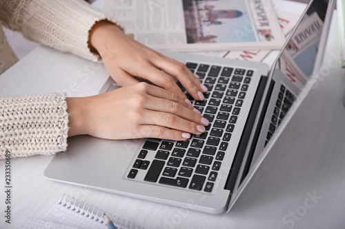 Woman using laptop on light...