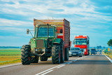 Agricultural tractor at highway road in Poland