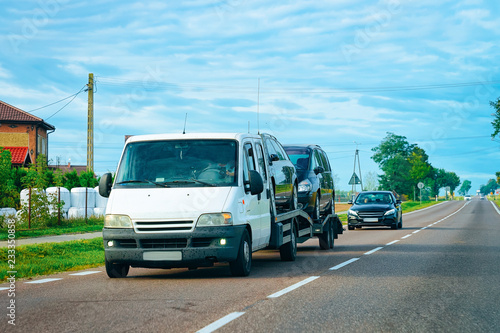 Wallpaper Mural Car carrying trailer with new vehicles at road in Slovenia Torontodigital.ca