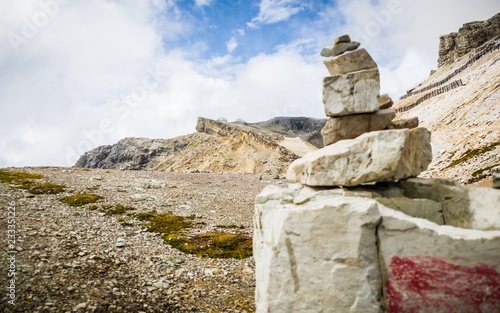 The Lagazuoi lodge, with a pile of stones in the foreground, Cortina d'Ampezzo, Dolomites, Italy. photo