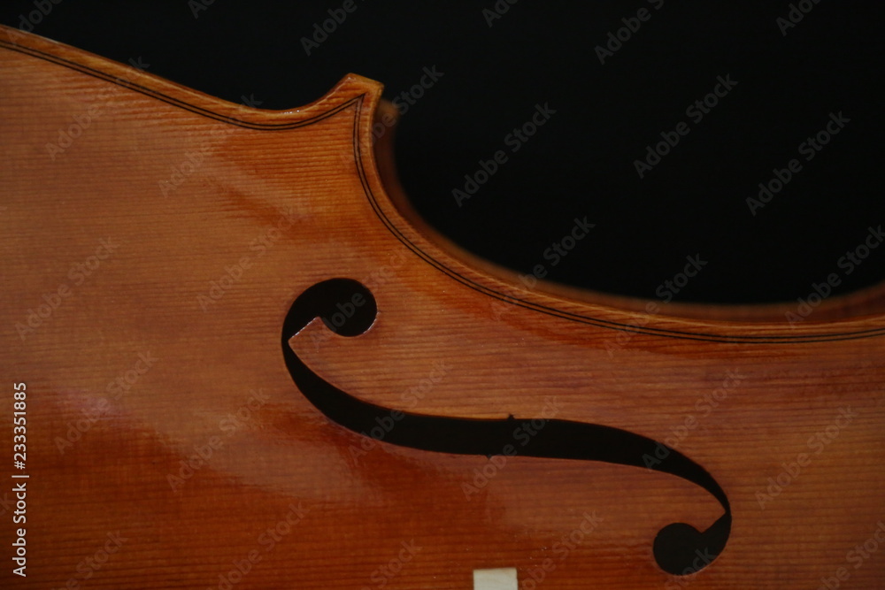 Violin detail with f detail isolated on black. Violin detail with f detail isolated on black.