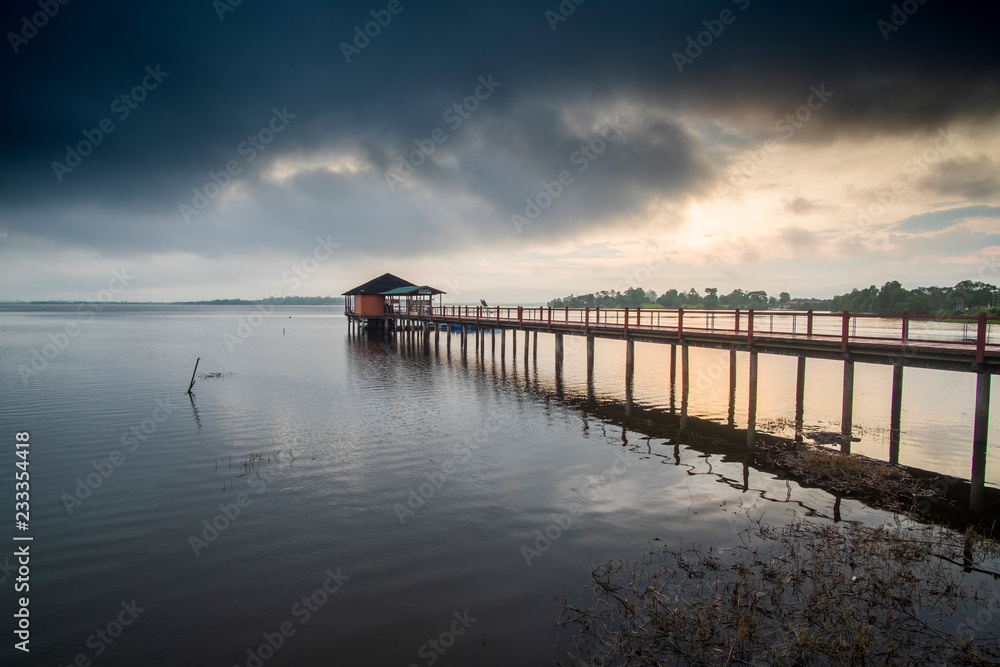 sunrise scenery at old jetty of Taiping Lake town. soft focus,blur due to long exposure. visible noise due to high ISO.