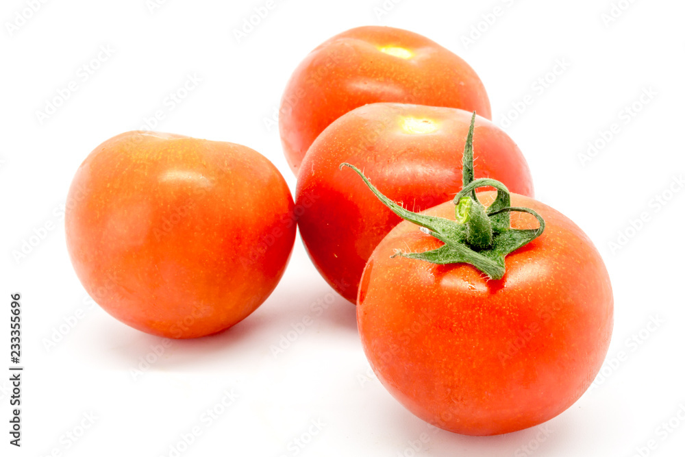 Ripe red tomatoes against a white background Ripe red tomatoes against a white background