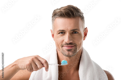 portrait of adult man with toothbrush looking at camera isolated on white