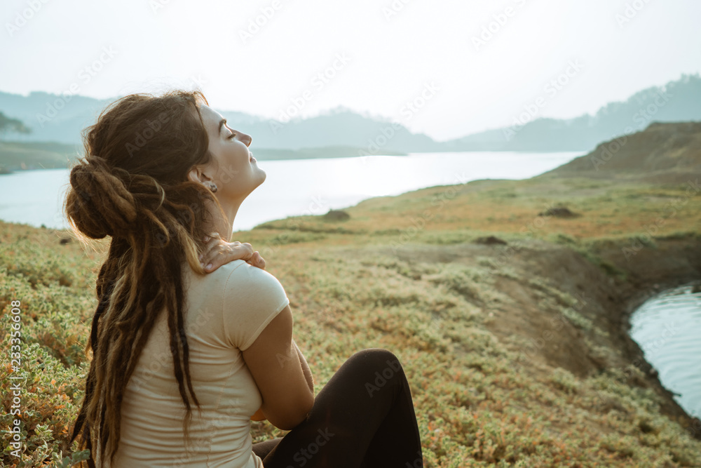 a woman enjoys fresh morning air