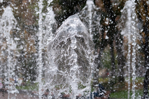Many water streams  water splashes and drops in the fountain. Abstract background of water trickles and drops.