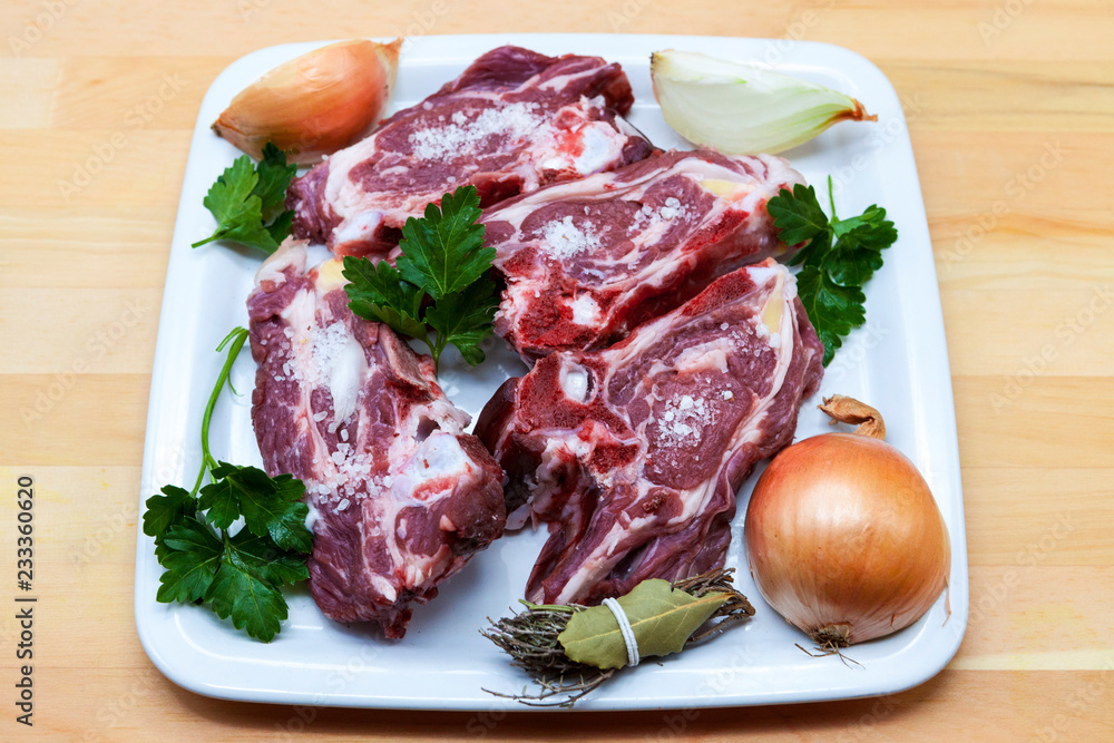 Pieces of fresh lamb on the plate . Delicious fat-tailed lamb with onion on the plate . Meat to be grilled. Pieces of fresh lamb on the plate . Delicious fat-tailed lamb with onion on the plate . Meat to be grilled.