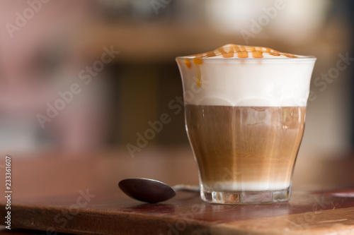 Принти на полотні Latte macchiato coffee on wooden desk in coffee shop