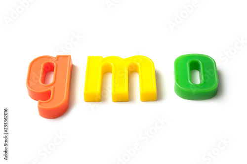 closeup of colorful plastic letters on white background - gmo