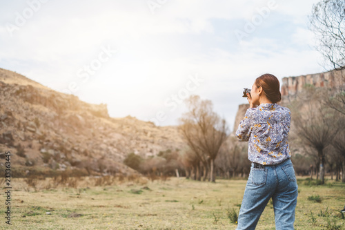 Back view Asian woman using camera  taking photo for landscape view photography © Nattakorn