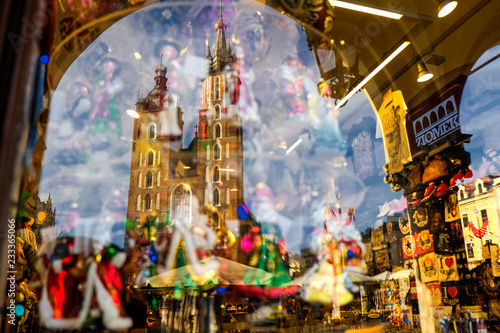 Reflection of the st. Mary's basilica in a shop window with Christmas decorations. Krakow, Poland. 12-10-2015