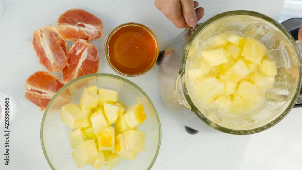 mixing of a fruit cocktail in a blender, smoothies from pumpkin, grapefruit and honey. Fitness and healthy lifestyle concept. 4K mixing of a fruit cocktail in a blender, smoothies from pumpkin, grapefruit and honey. Fitness and healthy lifestyle concept. 4K