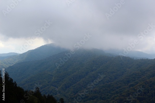 The fog and the mist of the low clouds over the mountains.