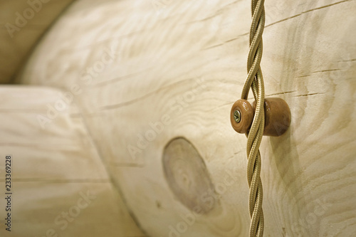 Wooden Swedish Cope profile log home wall with hinged wiring