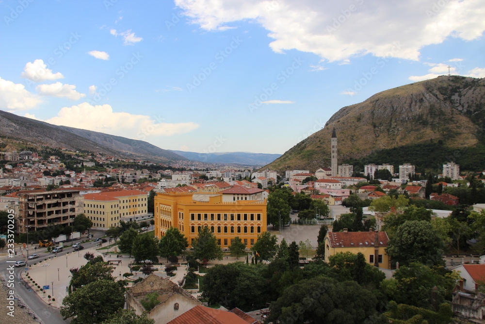 The historic town of Mostar, spanning a deep valley of the Neretva River, developed in the 15th and 16th centuries as an Ottoman frontier town and during the Austro-Hungarian period in the 19th