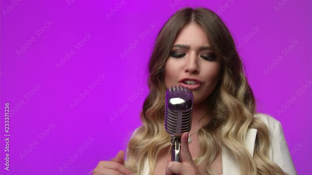 Blond Woman sings in studio in retro microphone Blond Woman sings in studio in retro microphone