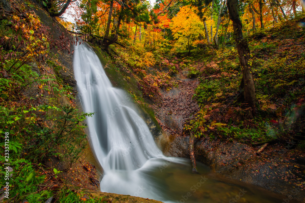 Waterfall among many foliage, In the fall leaves Leaf color change In Yamagata, Japan