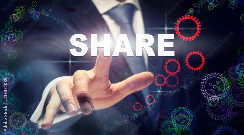 A businessman pressing a Share business concept on a graphical display of cogs A businessman pressing a Share business concept on a graphical display of cogs