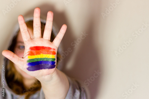 hand of the girl on which the flag of LGBT with the space for the text is represented