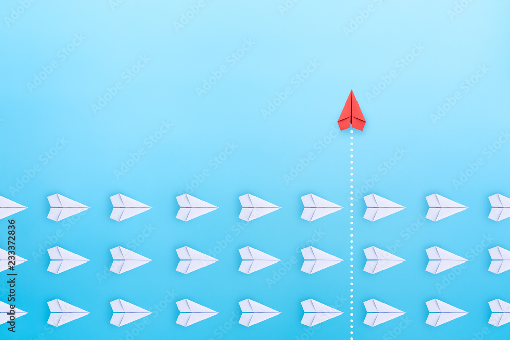 Group of white paper plane in one direction and one red paper plane ...