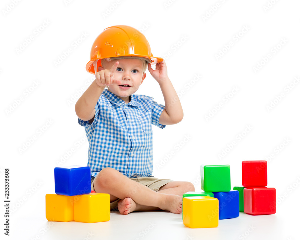 smiling child boy with hard hat and cubes toys smiling child boy with hard hat and cubes toys