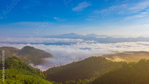 Aerial view above a Sea of fog coverage the mountains in the morning freshness. © Tanongsak