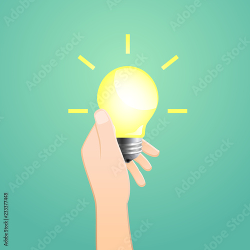 Hand holding glowing light bulb as innovation and idea concept