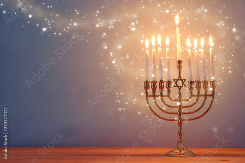 Photo image of jewish holiday Hanukkah background with menorah (traditional candelabra) and candles