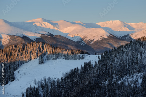 Winter landscape of a mountain range and valley in winter. © ianachyrva