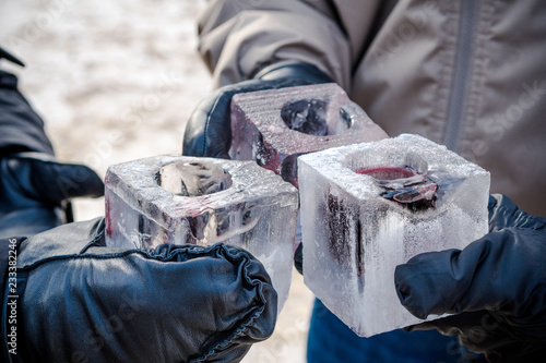 Group of people cheering with cups made out of ice