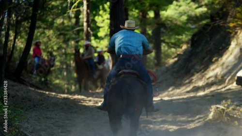 Horses galloping in Roundup on Dude Ranch with Cowboy Riders  photo