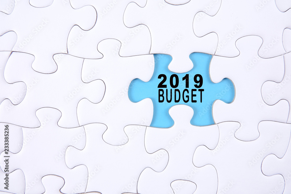 Business concept: 2019 BUDGET word on a jigsaw puzzle background. Business concept: 2019 BUDGET word on a jigsaw puzzle background.