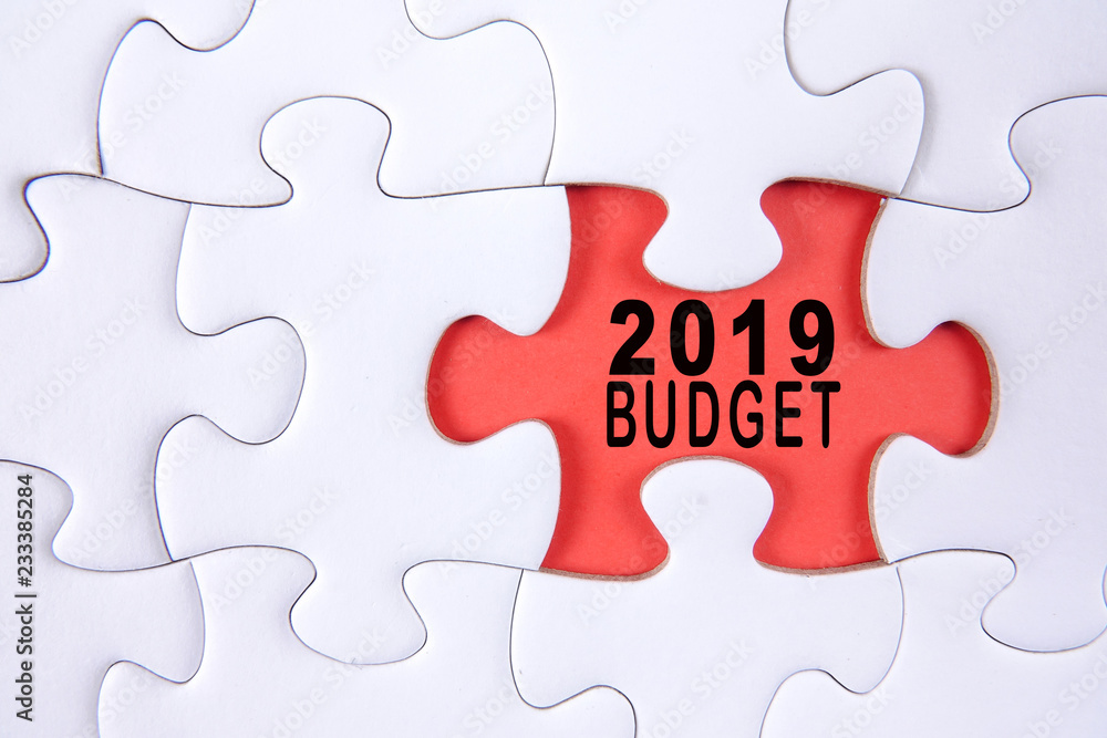 Business concept: 2019 BUDGET word on a jigsaw puzzle background. Business concept: 2019 BUDGET word on a jigsaw puzzle background.