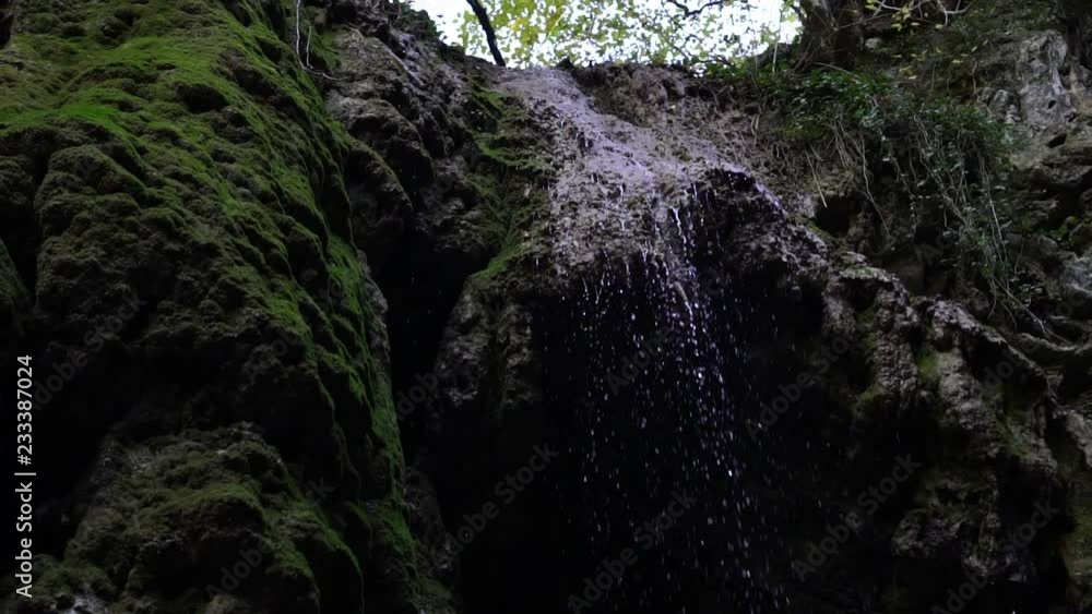 Beautiful tropical waterfall, water drops falling from the rock, slow motion. Beautiful tropical waterfall, water drops falling from the rock, slow motion.