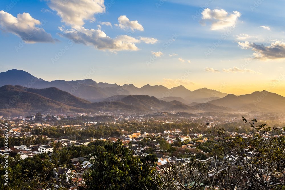 Landscape view over the city in the sunset lights from Mount Phousi, Laos