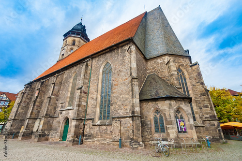 Great low angle view of the heritage-protected Evangelical-Lutheran St. Blasius Church standing in the historic town centre of Hann. Münden, Lower Saxony, Germany on a sunny day with a blue sky.