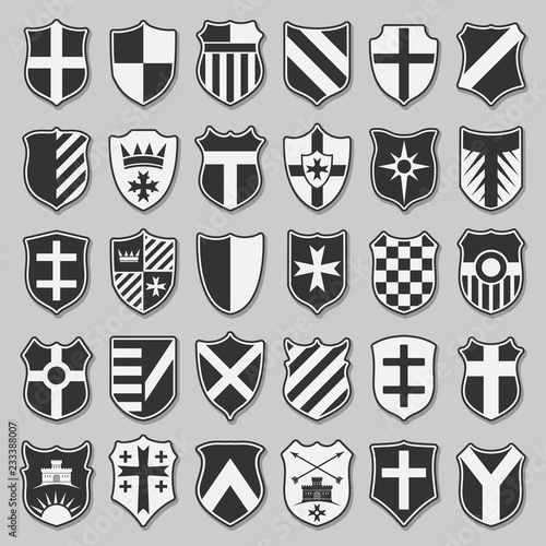 Set of heraldic shields with emblems over grey background. Isolated shields icons with contours. Vector silhouette elements for design.