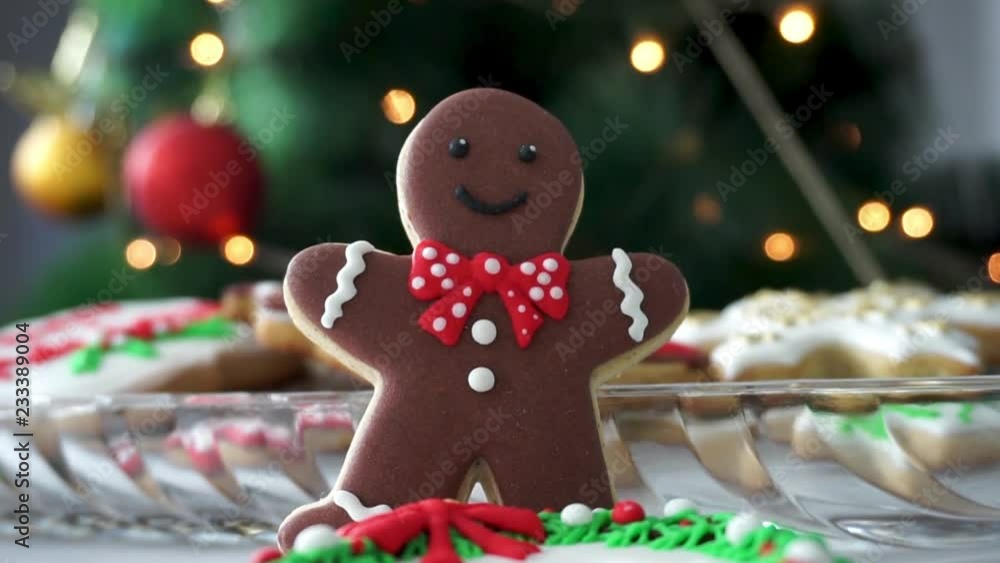Gingerbread Man cookie in front of a Christmas Tree Gingerbread Man cookie in front of a Christmas Tree
