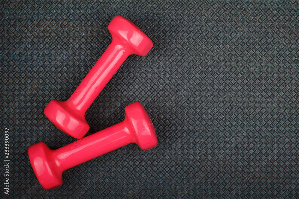 Dumbbells on yoga mat with copy space text, top view Dumbbells on yoga mat with copy space text, top view