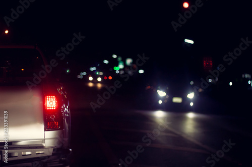 Cars on the road at night stop by traffic jam and light control.