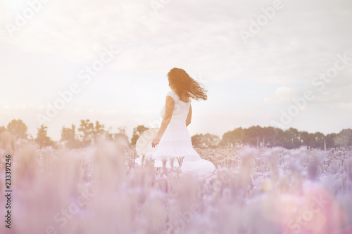 beautiful girl dancing in a field of purple flowers