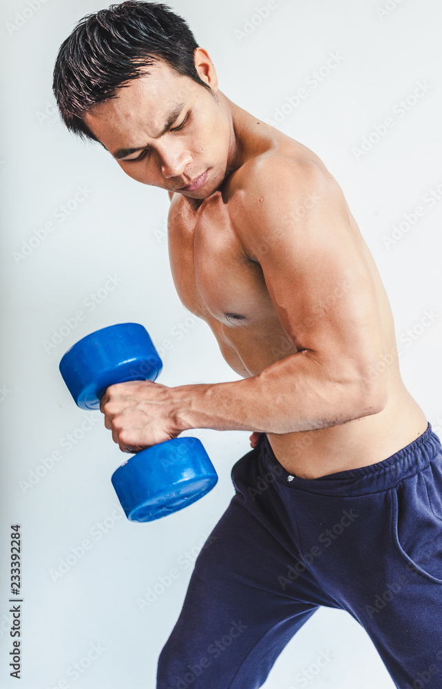 Asian young man with muscular body On the white back Asian young man with muscular body On the white back