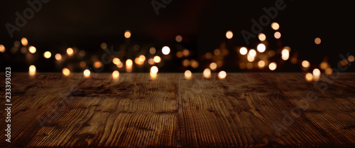 Gold and silver lights on dark wood photo