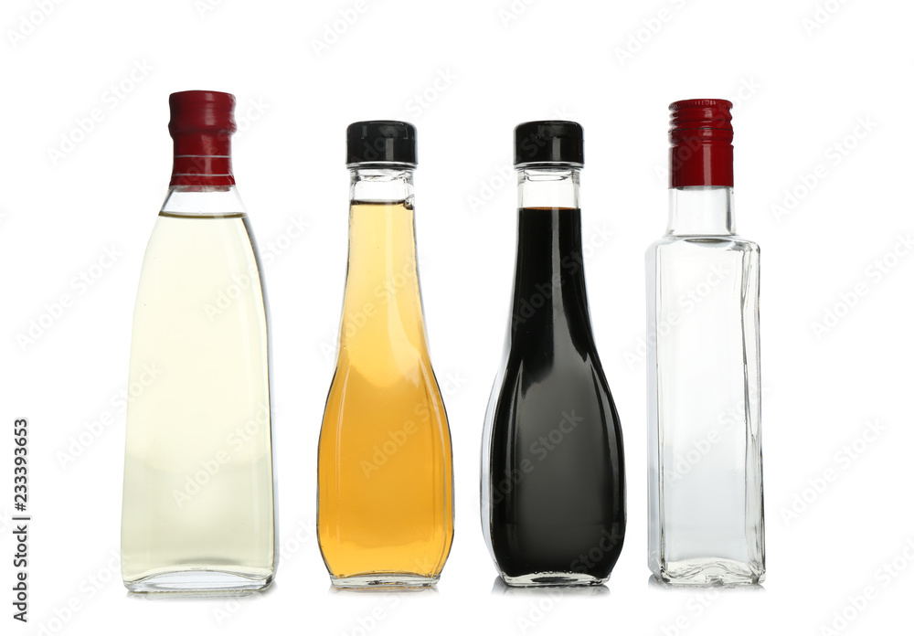 Glass bottles with different kinds of vinegar on white background Glass bottles with different kinds of vinegar on white background