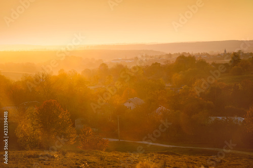 Foggy sunset at village panorama at autumn. Ukraine